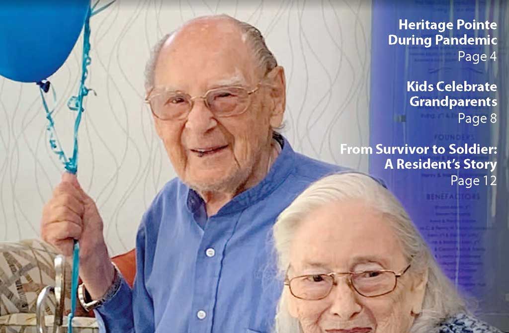 two heritage pointe residents male and female seniors smiling male holding blue balloon