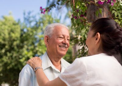 Senior man smiling at senior woman while outdoors
