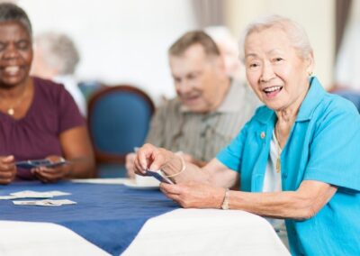 Senior woman smiling while playing cards