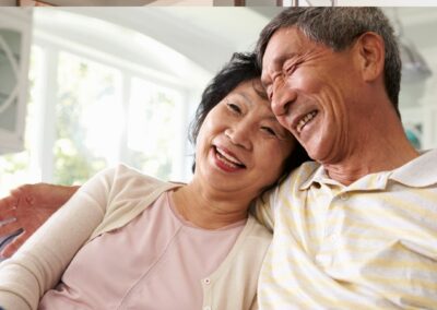 Senior couple laughing together on a couch