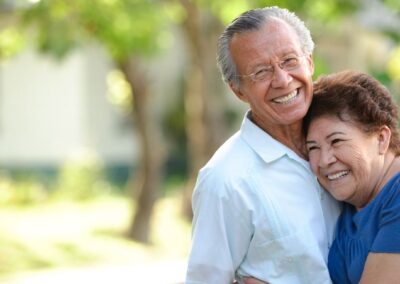 Senior couple smiling while embracing outside