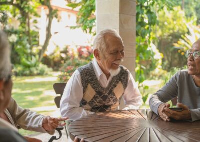 Group of seniors talking while sitting around a table