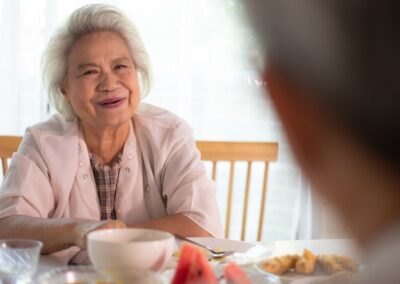 Senior woman smiling while at dinner table