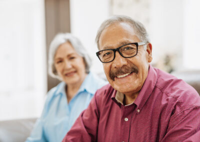 Senior couple smiling together on couch