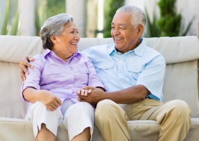 Senior couple smiling on outdoor couch